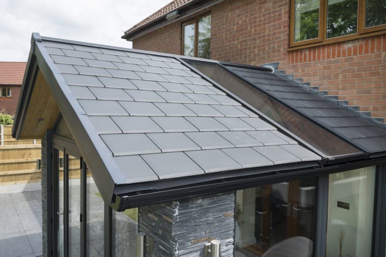 Black solid conservatory roof replacement with glazing panel