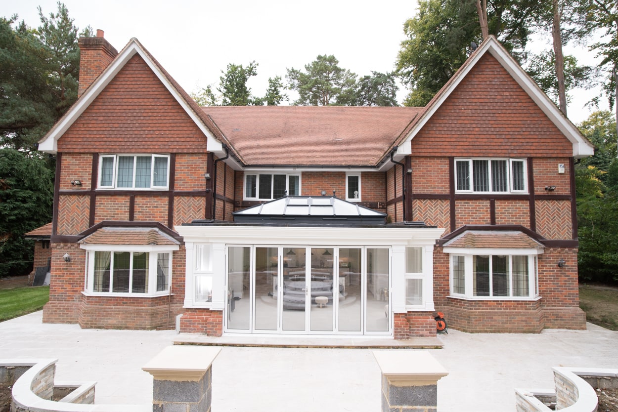 Modern orangery built on traditional home