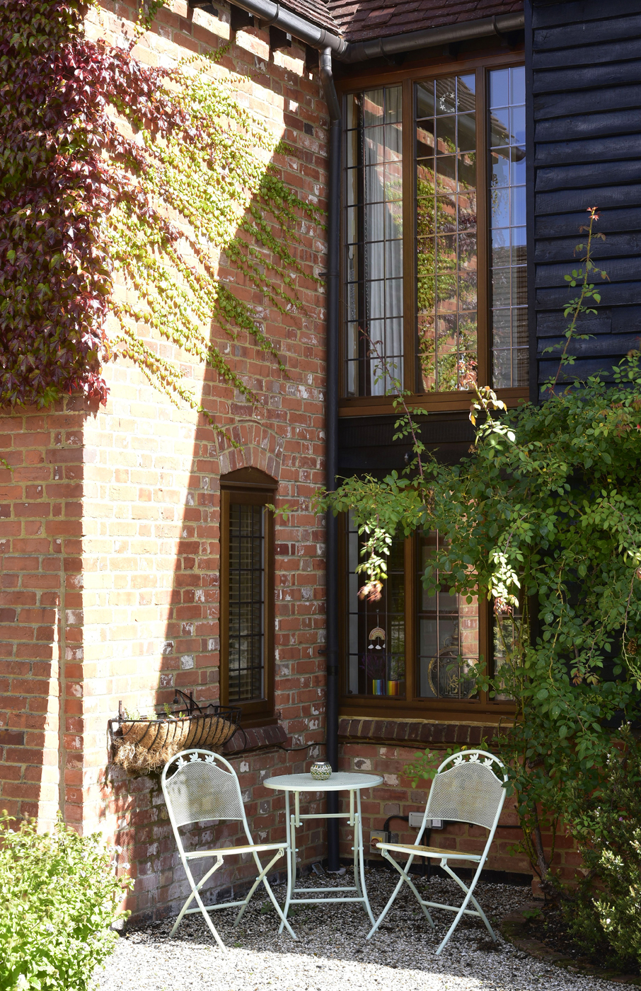 exterior shot of garden with brown residence windows