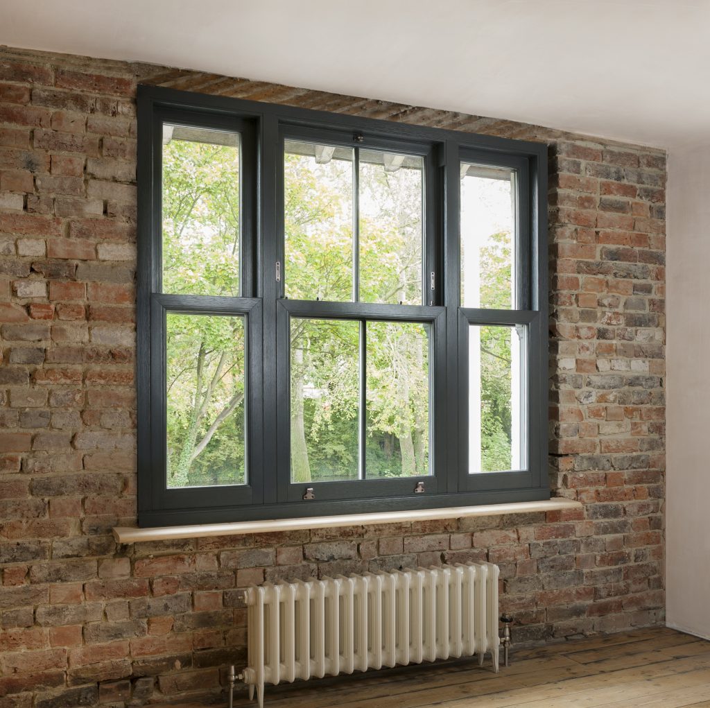 Black wood sash windows in red brick building.