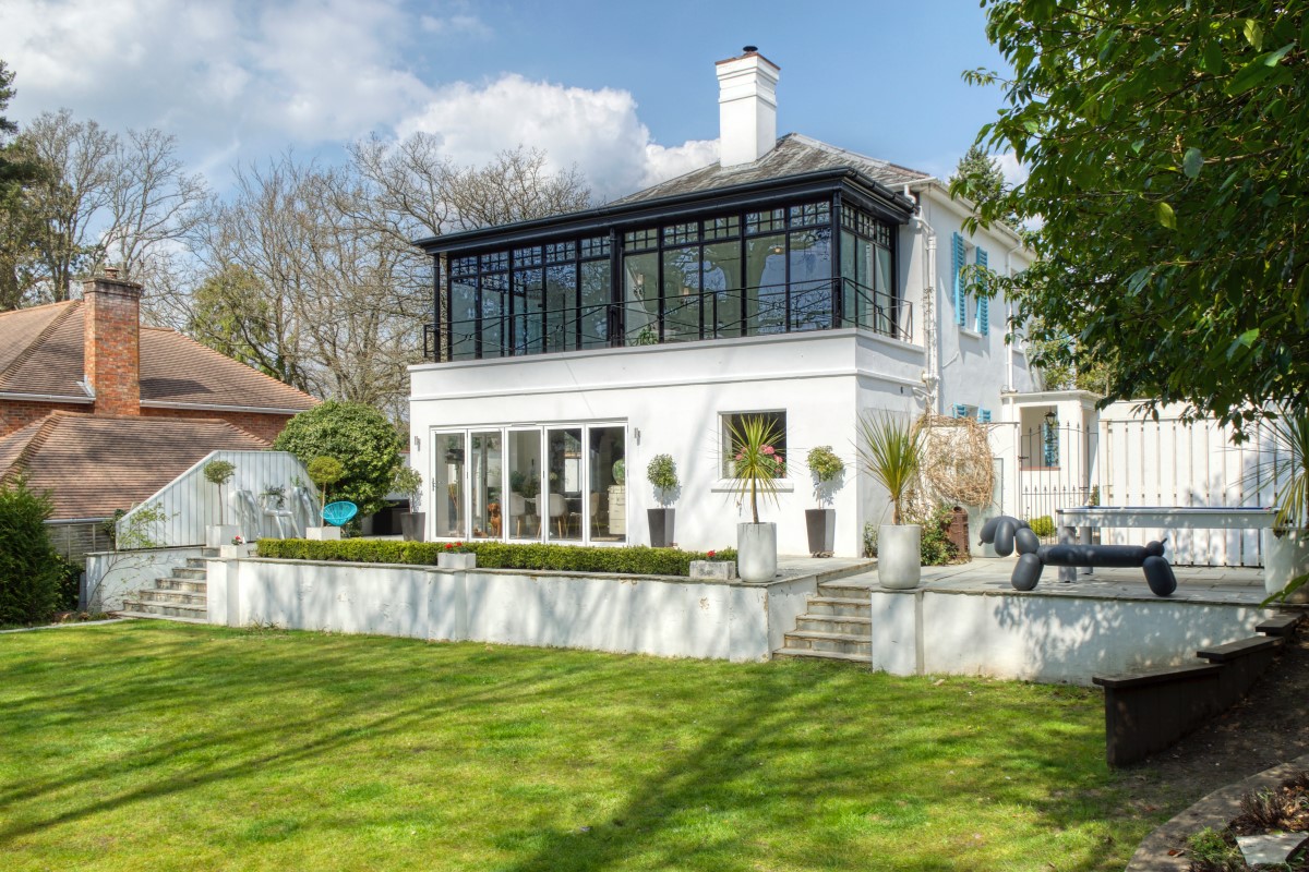 large white house in front of garden