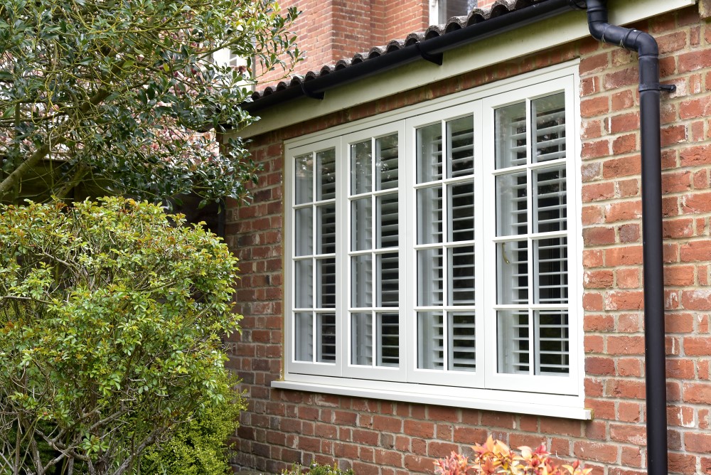 exterior view of white flush casement with window with georgian bars and internal blinds